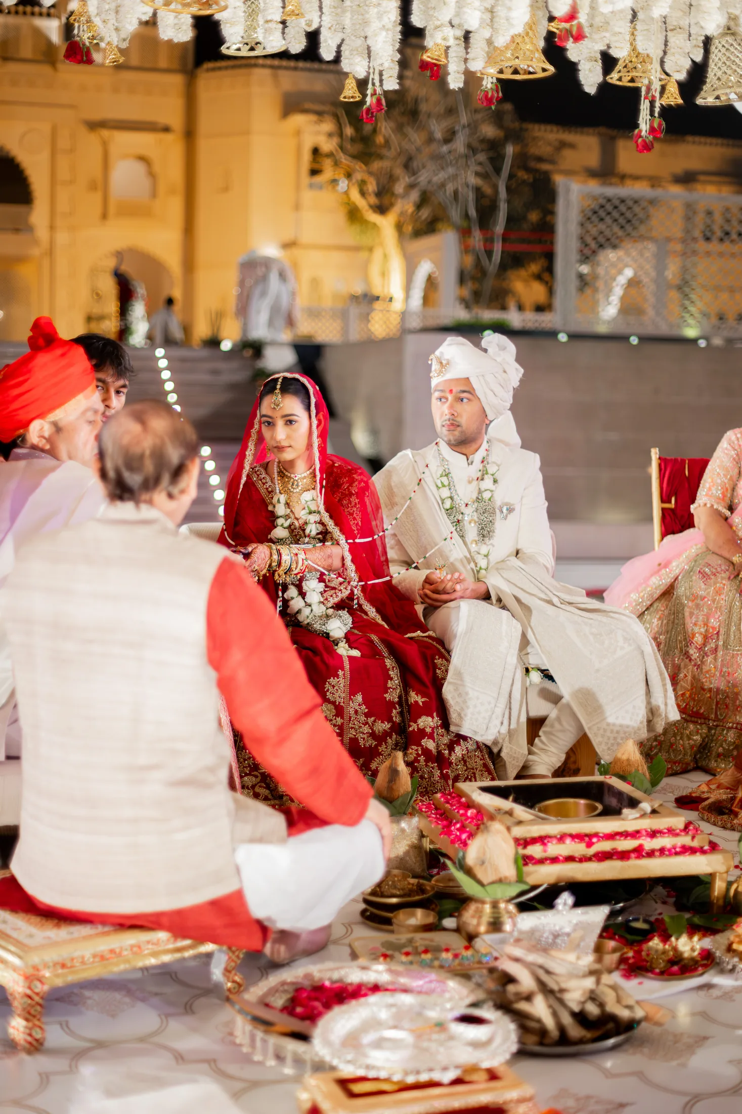 Jay and Serene sit together during the sacred fire wedding ritual