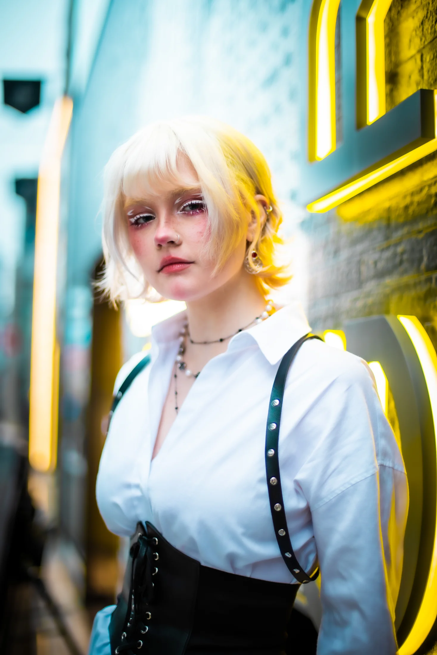 Close portrait of Ylva Brandt beside yellow neon