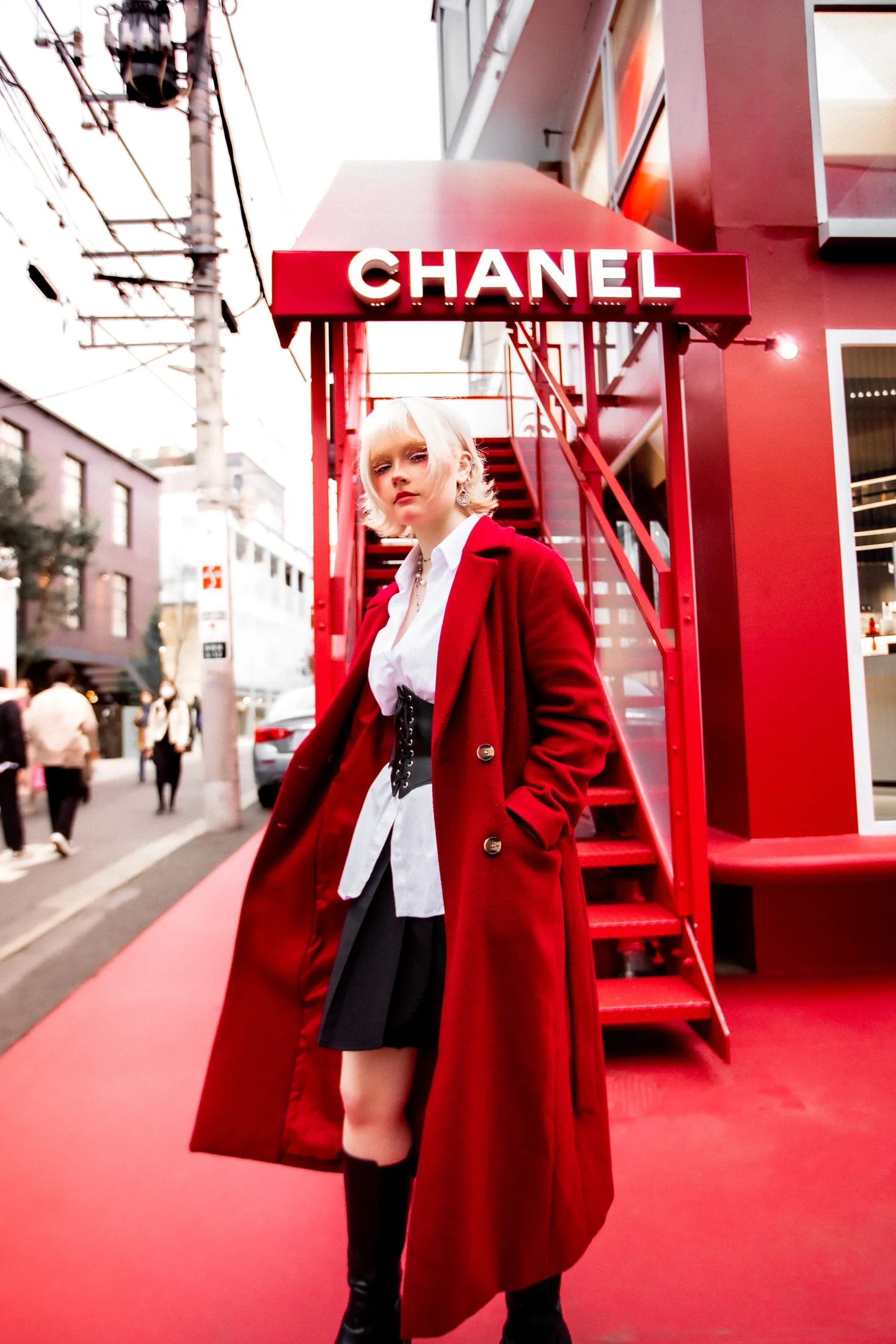 Ylva Brandt posing in a vivid red Tokyo streetscape